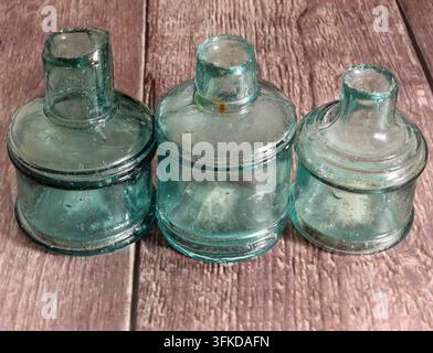 Three cotton reel, antique sheared top ink bottles Stock Photo