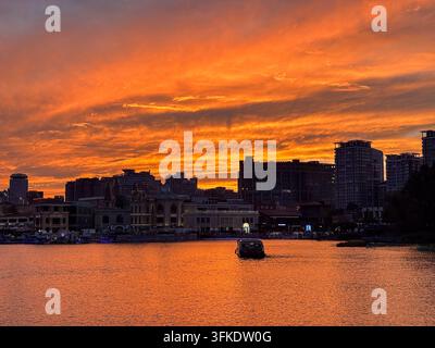 Sunset with fiery clouds over lake at Solana Mall, Beijing cityscape scenery Stock Photo