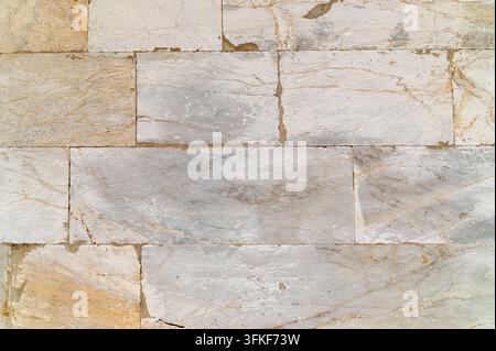 Marble tile wall displaying rectangular blocks in neutral tones. Stock Photo