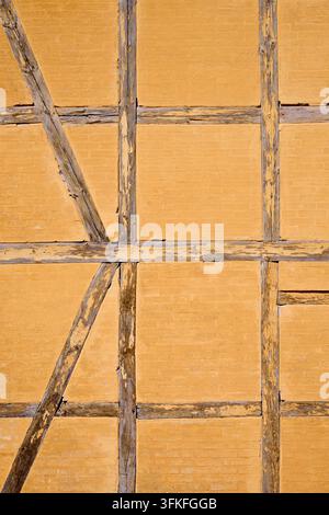 Close-up of an orange façade typical of the town of Roskilde. Built with wood and brick. Traditional framework in residence building. Stock Photo