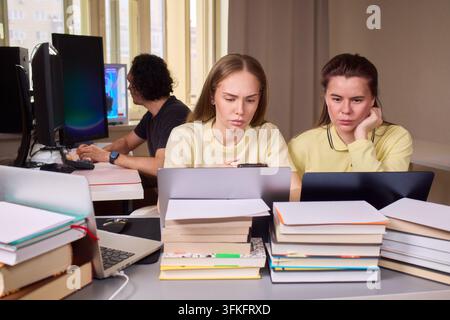 Colleagues work on design. Professionals analyze data and brainstorm in office environment. Team engaged in detailed discussion and analysis of Stock Photo