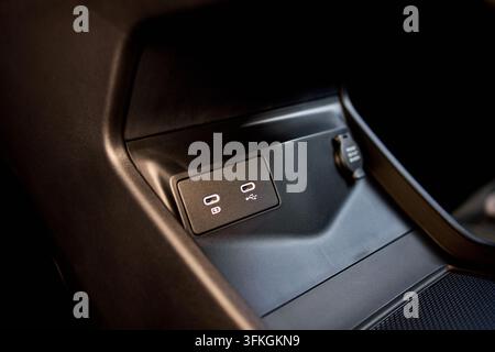 This close-up image showcases the interior design of a car door panel, featuring a combination of leather and plastic materials. The neutral setting h Stock Photo
