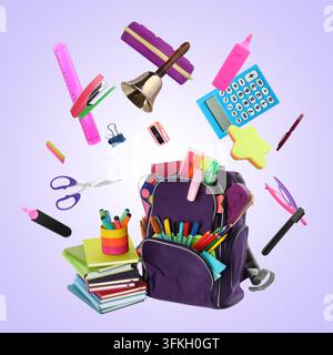 School bell and stationery flying over backpack against violet gradient background Stock Photo