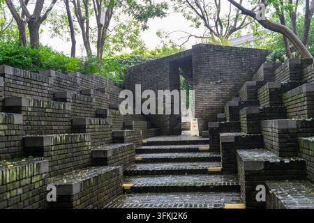 Grey brick amphitheater at Red Brick Art Museum on a rainy day, Beijing Stock Photo