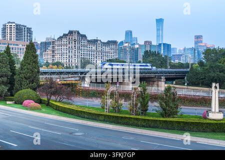 High-speed train traveling on an elevated railway bridge in the city Stock Photo