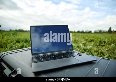 Laptop Computer with Blank Screen Placed Outdoors for Remote Work Stock Photo