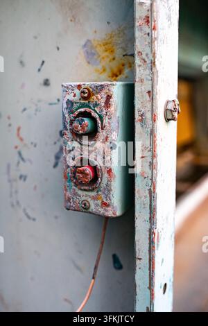 Old push button switch mounted on electrical distribution cabinet Stock Photo