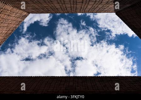 Looking up at blue sky and white clouds from the patio of Red Brick Art Museum in Beijing Stock Photo