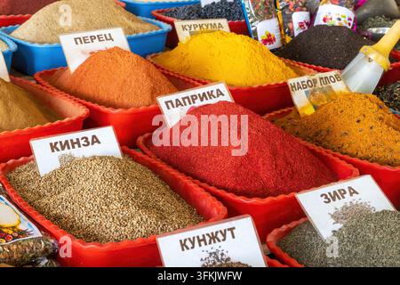 Colorful spices labeled with Cyrillic letters on display in a market in Tashkent, Uzbekistan Stock Photo