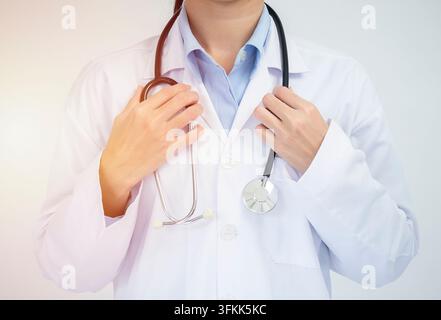 Crop image of professional confident young female asian doctor in white coat, stethoscope over neck, ready help patient, fight disease Stock Photo