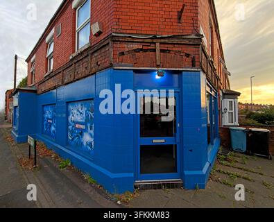 Sunset on closed & now empty Betfred betting shop at 137 Padgate Lane in Warrington, with blue shutters and former shop branding. Stock Photo