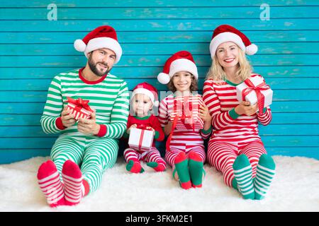 Happy family having fun at Christmas time. Father, mother and children at home. Xmas holiday concept Stock Photo