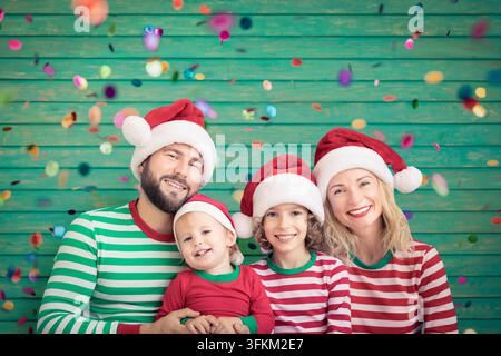 Happy family having fun at Christmas time. Father, mother and children at home. Xmas holiday concept Stock Photo