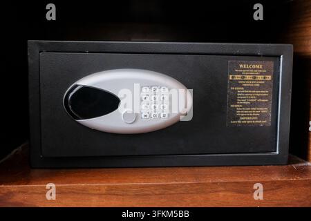 Electronic security safe box with digital keypad and instruction in a hotel room Stock Photo