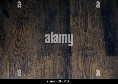 Close-up of dark brown wood flooring texture with natural grain patterns Stock Photo