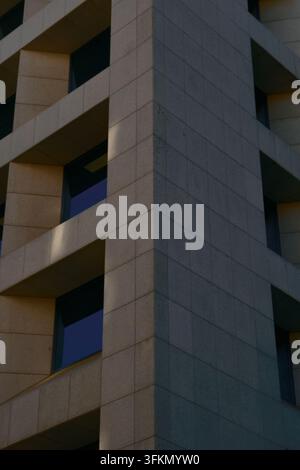 Abstract upward view of a modernist building in Lisbon, Portugal, with repeating balconies and strong geometric lines. Stock Photo