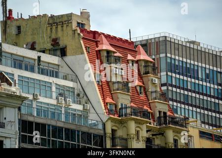 A striking contrast of architectural styles in Buenos Aires, featuring a ornate French-style building with red mansard roofs alongside modern glass fa Stock Photo