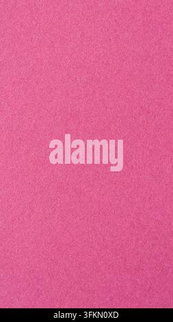 Pink paper texture with fine irregular fibers across a blank matte surface in vivid monochrome color Stock Photo
