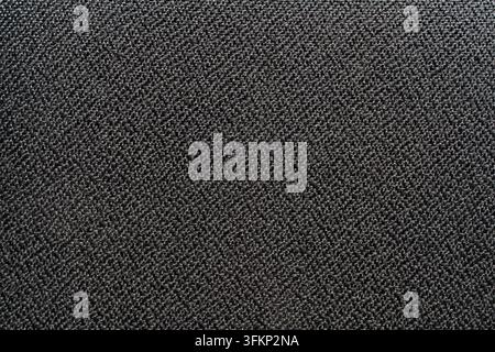 Dark grey woven fabric texture background. Detailed full frame close up background texture of dark grey or black tightly woven textile fabric material Stock Photo