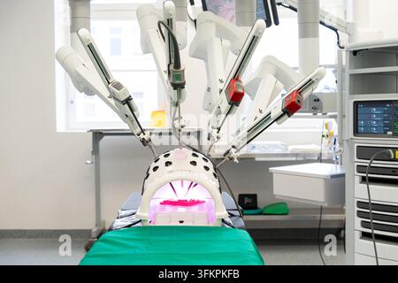 Da Vinci surgical robot system in modern hospital operating room, medical robotics technology concept. Stock Photo