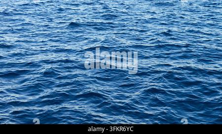 Blue sea water creating a wavy texture on the surface of the Mediterranean Stock Photo