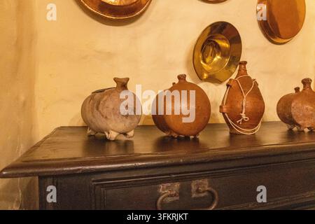 Abstract sepia-toned composition featuring layered dark organic shapes, curved linework, warm highlights, and a heavily textured paper-like surface. Stock Photo
