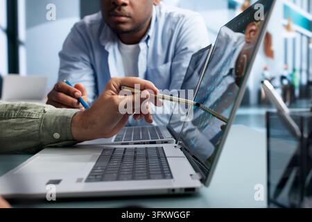 Data Scientist And Engineer Discuss AI Software Development Using Laptops. Stock Photo