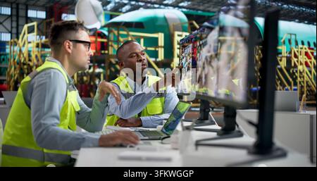 Engineer Closely Monitors Real-time Aircraft Data Using Advanced SCADA Software. Stock Photo