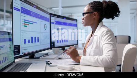 Healthcare Manager Carefully Reviews Medical Claims Using Laptop Software Platform For Authorization Decisions. Stock Photo