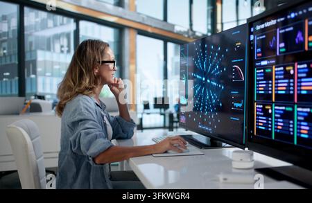 Data Scientist Carefully Analyzes Neural Network Models Using Advanced Software Tools At Workplace. Stock Photo