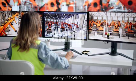 Engineer Uses Computer To Monitor Automotive Plant’s Real-time Production Line. Stock Photo