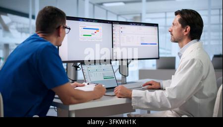 Healthcare Manager Carefully Reviews Billing Claims On Laptop For Accuracy. Stock Photo