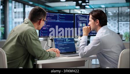 Software Engineer Coding Secure Algorithms While Collaborating At Desk. Stock Photo