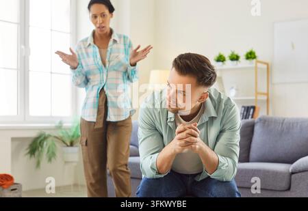 Frustrated boyfriend and girlfriend facing a relationship conflict and arguing at home Stock Photo