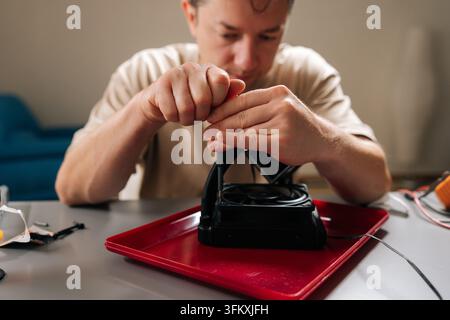 Skilled technician performing maintenance and installation on sophisticated cooling system for computer cpu, ensuring efficient heat dissipation and Stock Photo