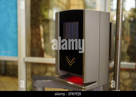 Electronic ticket validator device for public transit with a screen showing a screen glitch, used for gate access control and fare validation Stock Photo