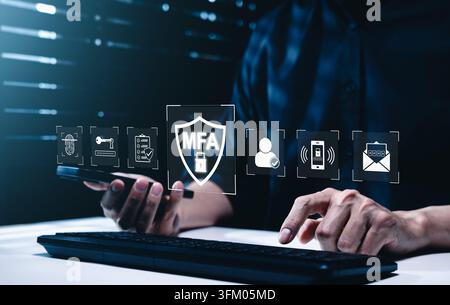MFA Multi factor authentication concept. Person using computer and smartphone, biometric login, password protection, user verification, mobile approva Stock Photo