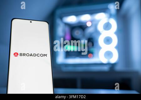 The Broadcom Inc. logo, representing the semiconductor company, is shown in front of an RGB-lit gaming PC, 11.07.2026. Stock Photo