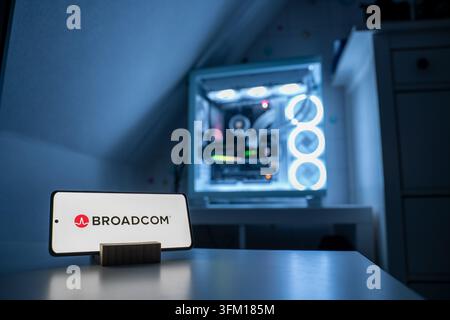 The Broadcom Inc. logo, representing the semiconductor company, is shown in front of an RGB-lit gaming PC, 11.07.2026. Stock Photo