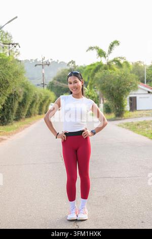 Fit Young Asian Woman in Sportswear Standing Outdoors in Street Ready for Jogging Stock Photo