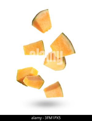 Pieces of cantaloupe melon falling on white background Stock Photo