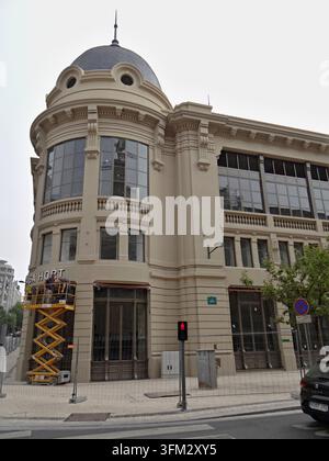 Construction workers using a cherry picker for renovation work on a historic building Stock Photo