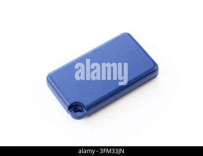 A small blue plastic key fob lays flat on white Stock Photo