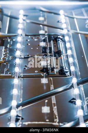 Technician fixes internal lights of a dismantled monitor Stock Photo