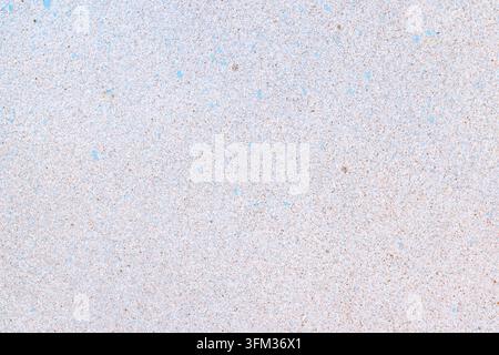 Concrete wall surface presenting a speckled blue and brown texture on a light gray background, providing an abstract pattern suitable for various desi Stock Photo