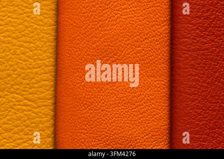 Close up view of luxury yellow orange and red leather showing fine organic pebble grain patterns and a soft matte finish with rich split tones Stock Photo