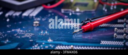 Computer Motherboard Inspection with Precision Multimeter Probes for Electronics Engineering, Repair and Quality Control Stock Photo
