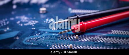 Computer Motherboard Inspection with Electrical Test Probes for PCB Repair, Voltage Measurement and Electronics Engineering Stock Photo