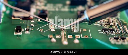 Soldering Iron and Solder Wire Repairing Printed Circuit Board for Electronics Maintenance, PCB Assembly and Technical Service Stock Photo