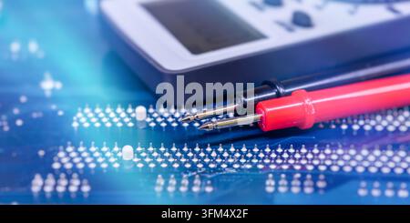 Digital Multimeter and Test Probes on Printed Circuit Board for Electronics Diagnostics and Electrical Repair Stock Photo